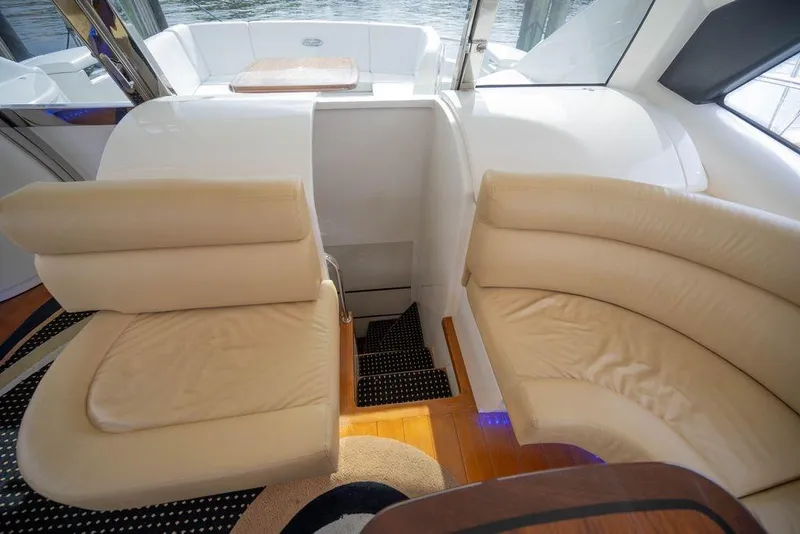 Slide: The Image of Luxurious interior seating on a 2007 Pershing 62' yacht with beige leather upholstery. - 32