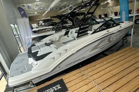 Slide: The Image of 2025 Chaparral 23 Surf boat displayed in showroom, featuring sleek design and modern amenities. - 7