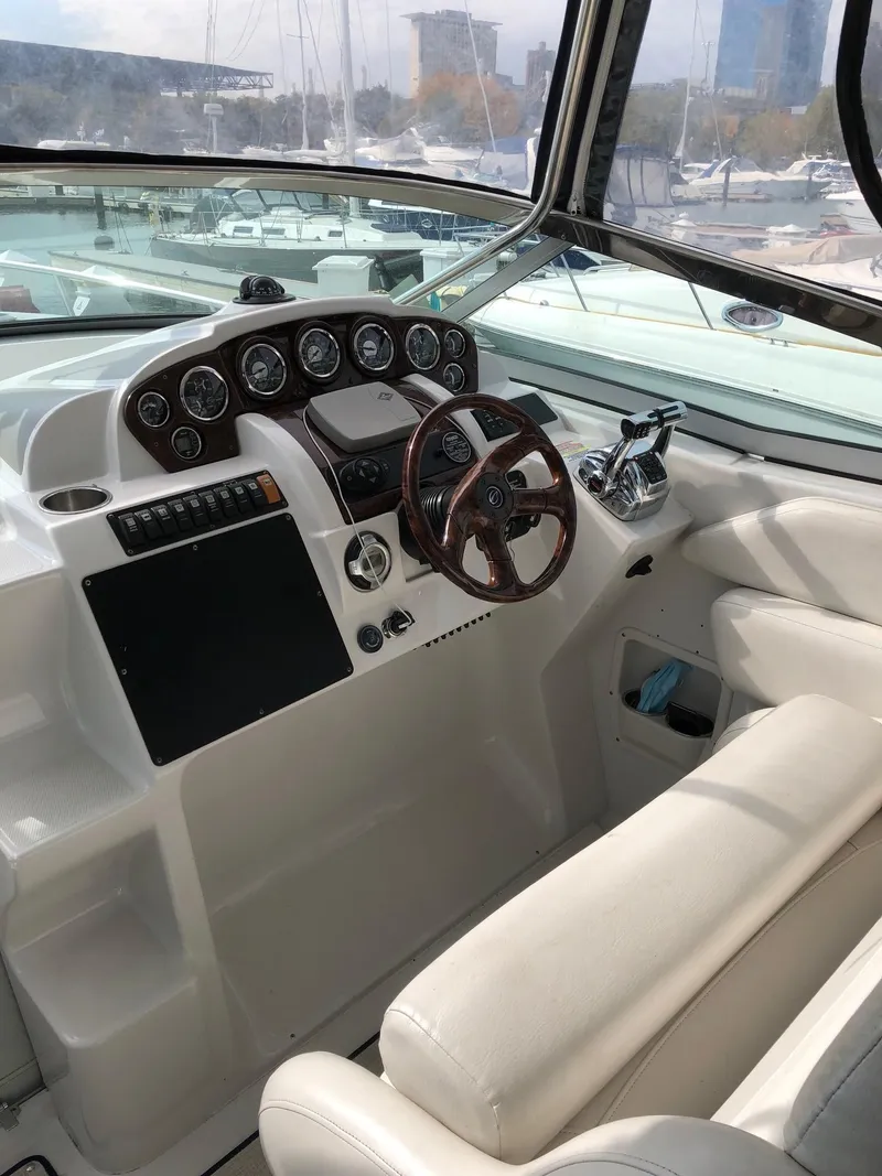 Slide: The Image of 2008 Crownline 340 CR boat cockpit with steering wheel and control panel. - 12