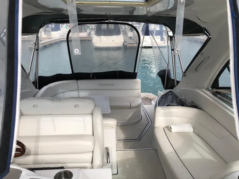Slide: The Image of 2008 Crownline 340 CR yacht interior with white seating and marina view. - 13