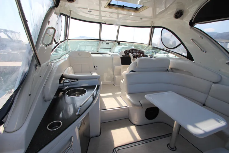 Slide: The Image of 2008 Crownline 340 CR yacht interior with seating, table, and kitchenette. - 14