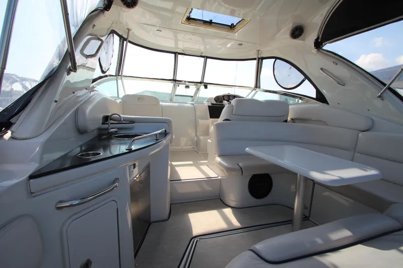 Slide: The Image of Interior of 2008 Crownline 340 CR boat with seating and kitchenette. - 15