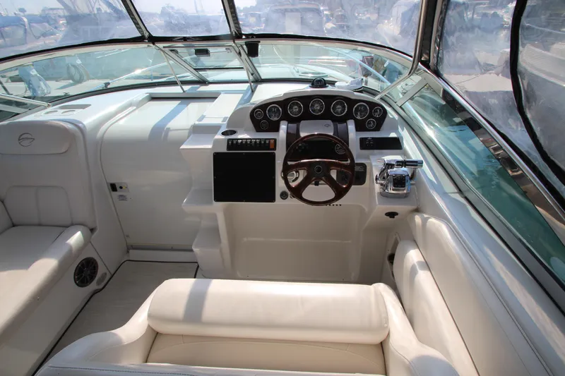 Slide: The Image of 2008 Crownline 340 CR boat cockpit with steering wheel and control panel. - 16