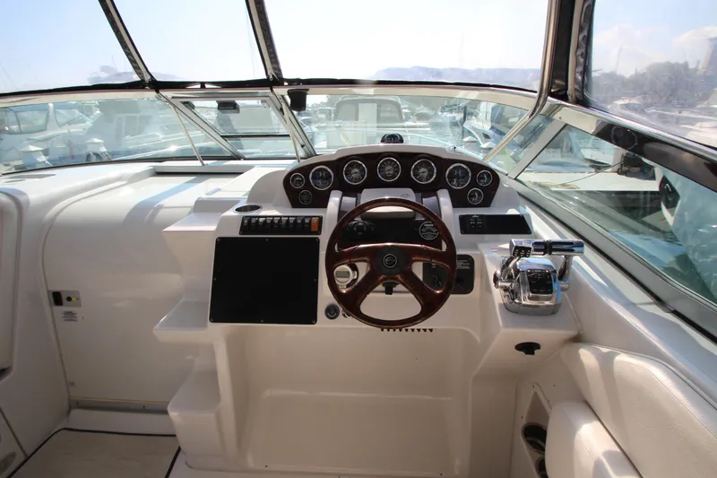 Slide: The Image of 2008 Crownline 340 CR boat helm with steering wheel and control panel. - 17