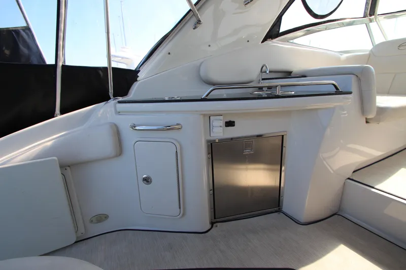 Slide: The Image of 2008 Crownline 340 CR yacht interior with kitchenette and seating area. - 21