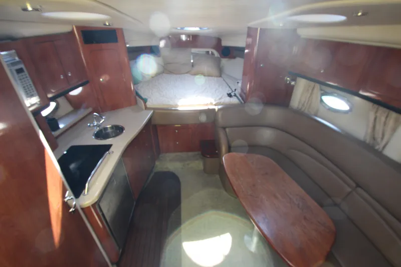 Slide: The Image of 2008 Crownline 340 CR cabin interior with kitchenette, seating, and bed. - 22