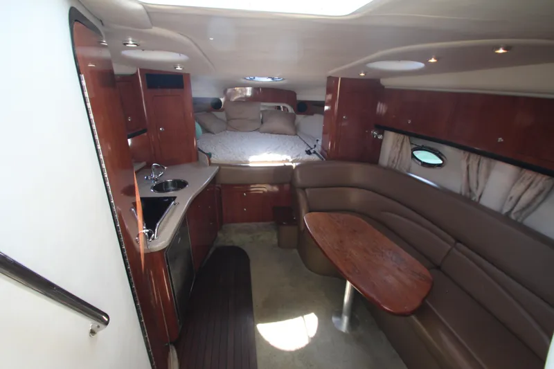 Slide: The Image of 2008 Crownline 340 CR cabin interior with kitchenette, seating, and bed. - 24