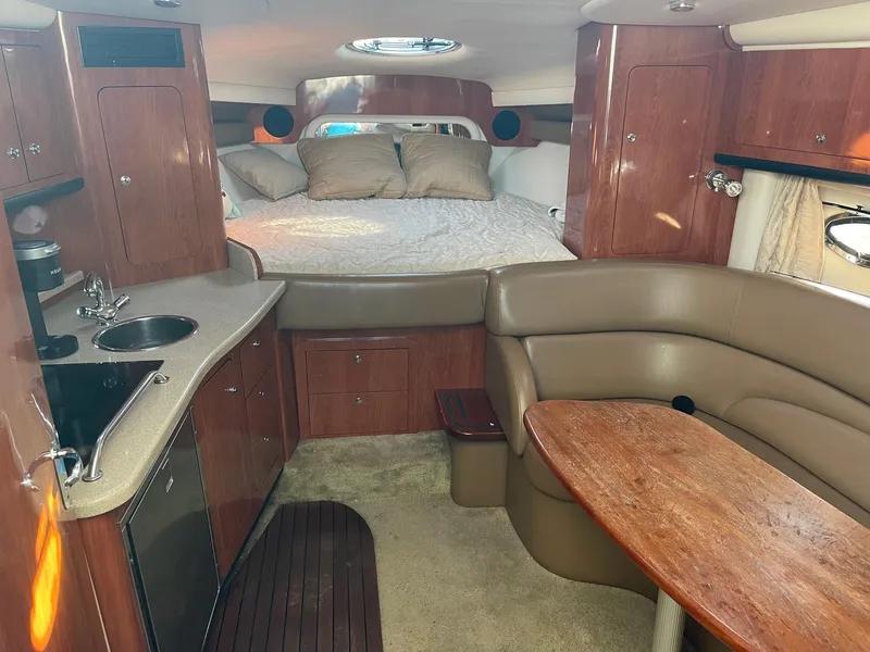 Slide: The Image of 2008 Crownline 340 CR cabin interior with kitchenette, seating, and bed. - 25
