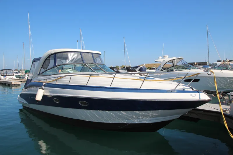 Slide: The Image of 2008 Crownline 340 CR boat docked in marina under clear blue sky. - 3