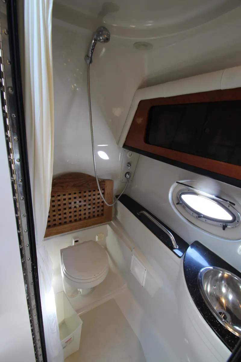 Slide: The Image of 2008 Crownline 340 CR boat bathroom with shower, sink, and porthole window. - 39