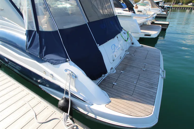 Slide: The Image of 2008 Crownline 340 CR boat docked with covered deck and wooden platform. - 4