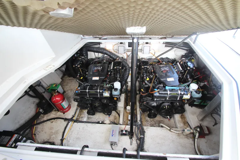 Slide: The Image of Engine compartment of a 2008 Crownline 340 CR boat, featuring dual engines and a fire extinguisher. - 43