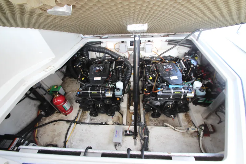 Slide: The Image of Engine compartment of a 2008 Crownline 340 CR boat, featuring dual engines and a fire extinguisher. - 44