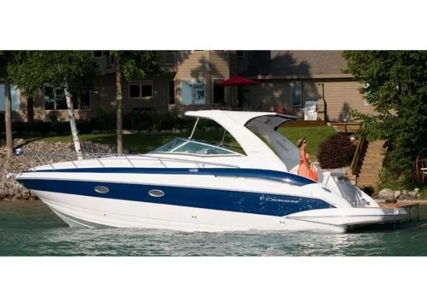 Slide: The Image of 2008 Crownline 340 CR boat on a serene lake near a house. - 46
