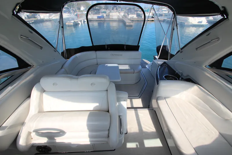 Slide: The Image of 2008 Crownline 340 CR yacht interior with white seating and marina view. - 9