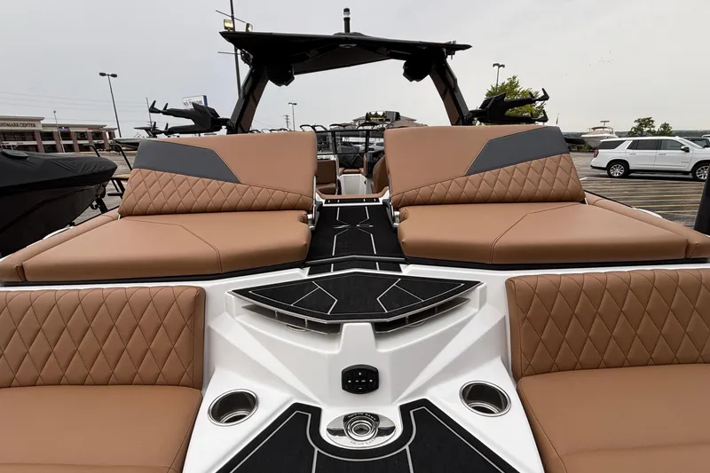 Slide: The Image of 2026 Tigé Z5 boat with luxurious tan seating and modern design in a parking lot. - 14