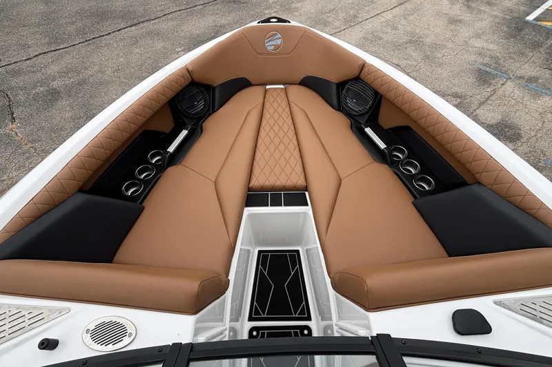 Slide: The Image of 2026 Tigé Z5 boat interior with tan and black seating, cup holders, and speakers. - 17