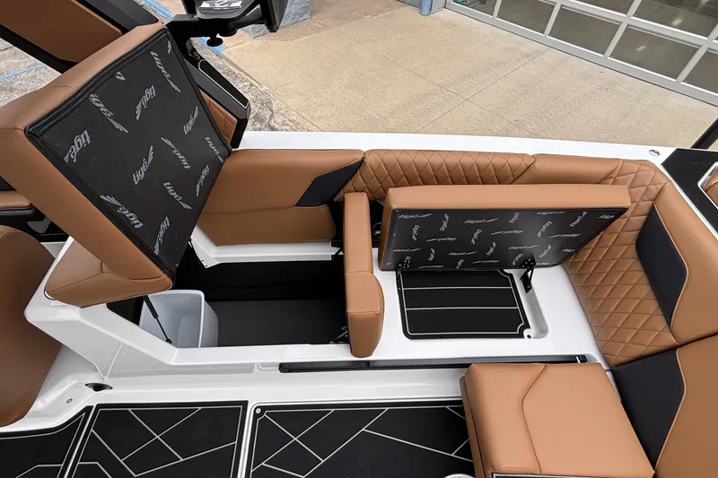 Slide: The Image of 2026 Tigé Z5 boat interior with brown leather seats and storage compartments. - 27