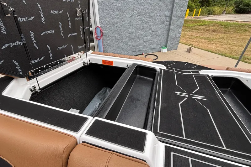 Slide: The Image of 2026 Tigé Z5 boat storage compartment with open hatch, showcasing interior space. - 33