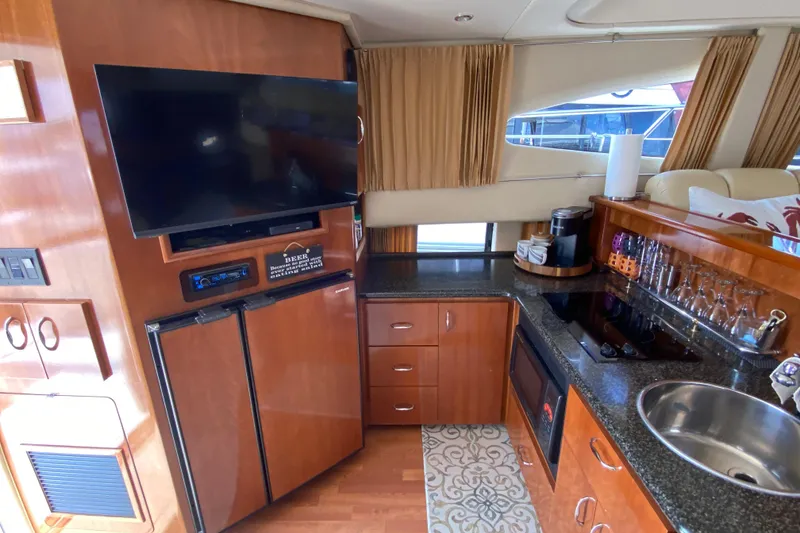 Slide: The Image of Interior of 2004 Carver 36 Super Sport yacht with kitchen and entertainment area. - 11