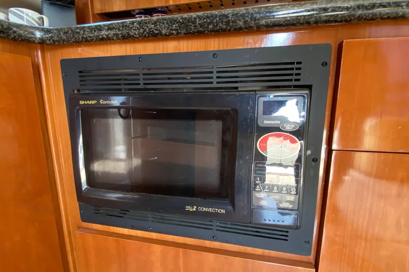 Slide: The Image of Built-in Sharp Carousel microwave in 2004 Carver 36 Super Sport yacht kitchen. - 13