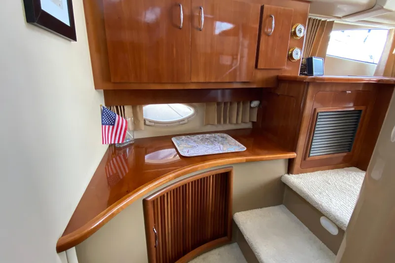 Slide: The Image of 2004 Carver 36 Super Sport interior with wooden cabinetry and American flag decor. - 20
