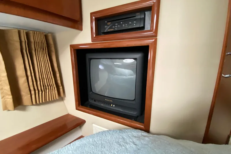 Slide: The Image of 2004 Carver 36 Super Sport interior with built-in Panasonic TV and DVD player. - 25