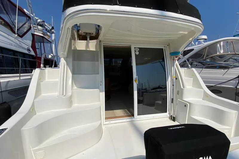 Slide: The Image of 2004 Carver 36 Super Sport yacht with open sliding doors and exterior stairs. - 3
