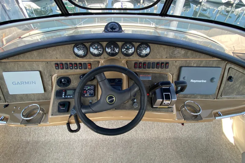 Slide: The Image of 2004 Carver 36 Super Sport helm with Garmin and Raymarine navigation systems. - 36