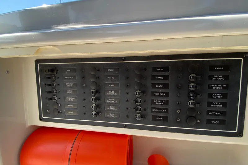 Slide: The Image of Control panel of a 2004 Carver 36 Super Sport boat with labeled switches. - 42
