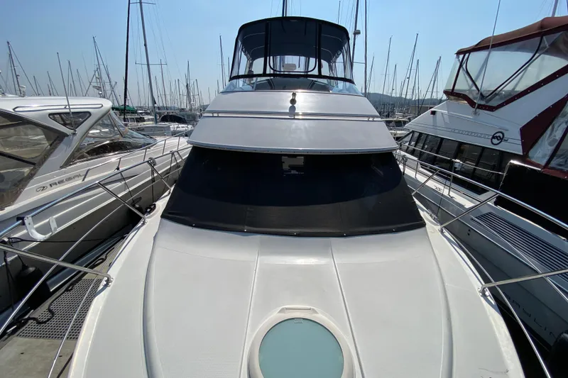 Slide: The Image of 2004 Carver 36 Super Sport yacht docked at marina, surrounded by other boats. - 50