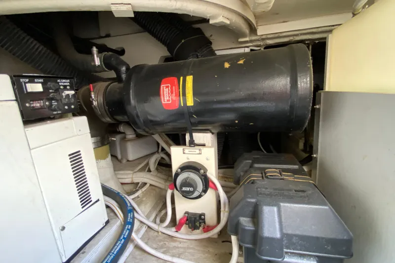 Slide: The Image of Engine room of 2004 Carver 36 Super Sport boat, featuring mechanical components and wiring. - 54