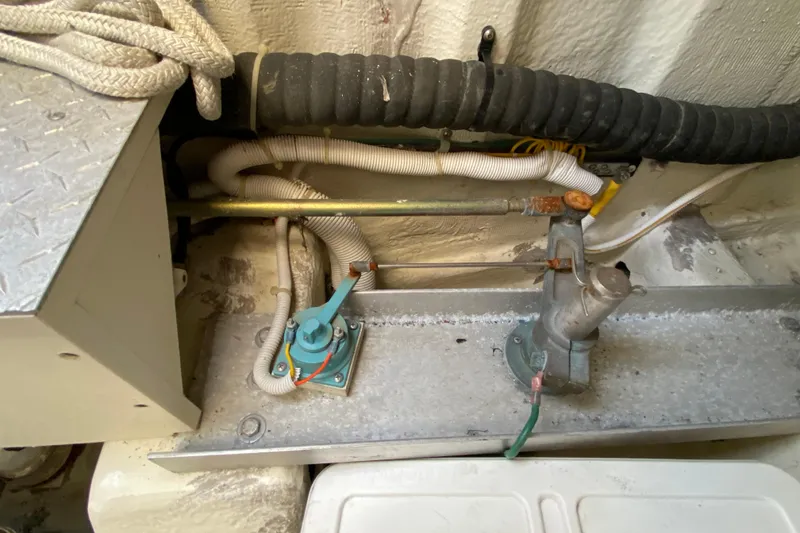 Slide: The Image of Engine compartment of a 2004 Carver 36 Super Sport boat, showing mechanical components and wiring. - 57