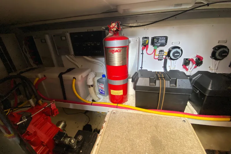 Slide: The Image of Engine room of 2004 Carver 36 Super Sport with fire extinguisher and equipment. - 59