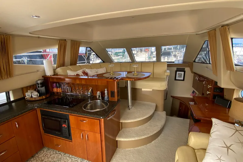 Slide: The Image of Interior of 2004 Carver 36 Super Sport yacht with kitchen and seating area. - 6