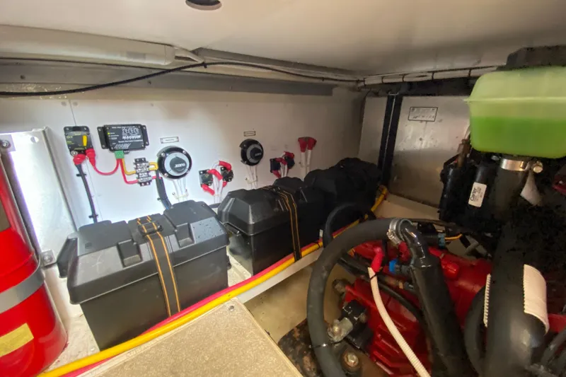 Slide: The Image of Engine room of a 2004 Carver 36 Super Sport, featuring batteries and control systems. - 60