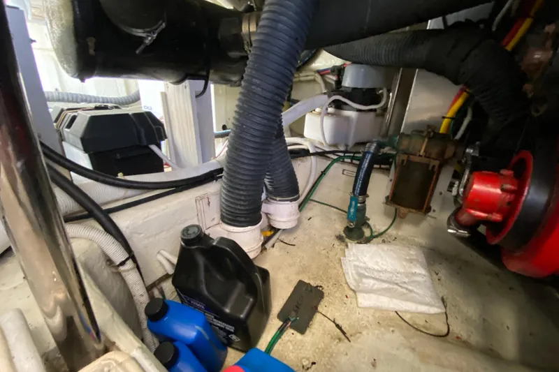 Slide: The Image of Engine room of 2004 Carver 36 Super Sport with hoses and maintenance supplies. - 68