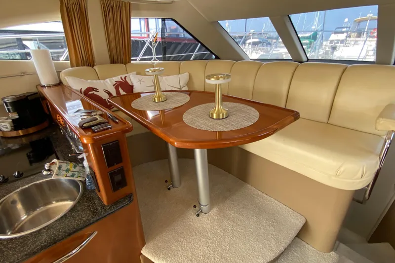 Slide: The Image of Luxurious interior of 2004 Carver 36 Super Sport yacht with elegant seating and dining area. - 8