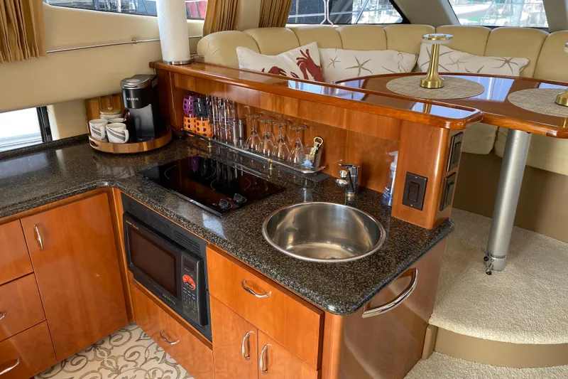 Slide: The Image of Luxurious 2004 Carver 36 Super Sport yacht interior with kitchenette and seating area. - 9