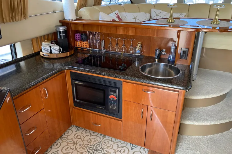 Slide: The Image of Luxurious 2004 Carver 36 Super Sport yacht kitchen with modern amenities and elegant design. - 10