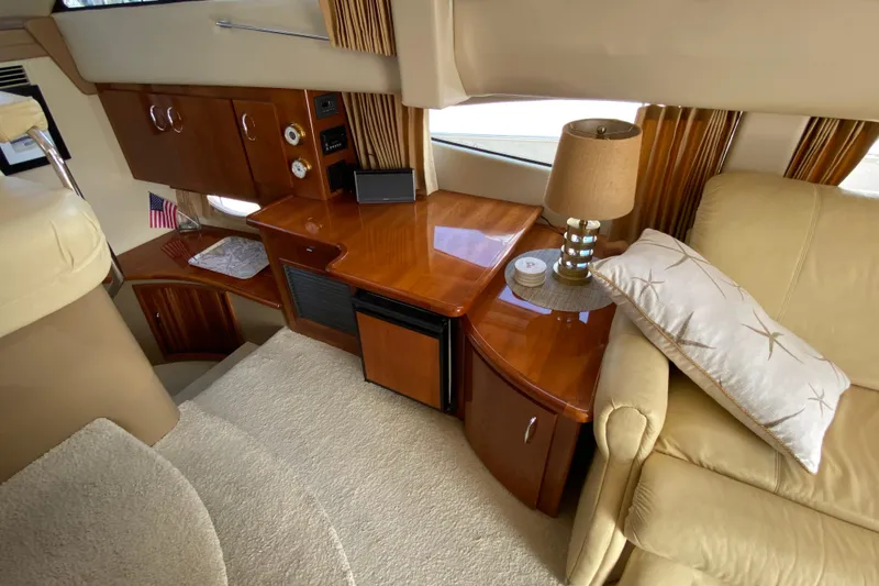 Slide: The Image of Interior of 2004 Carver 36 Super Sport yacht with elegant wood cabinetry and cozy seating. - 16