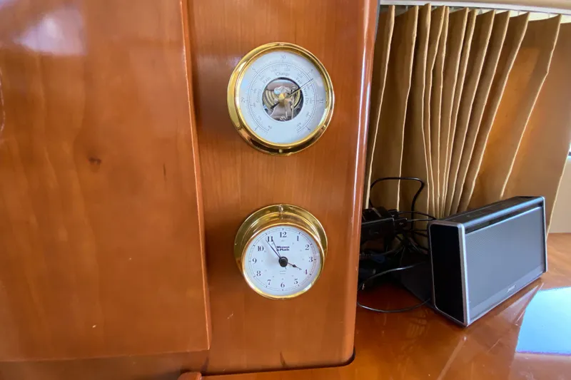 Slide: The Image of Wooden panel with clock and barometer on a 2004 Carver 36 Super Sport yacht. - 17