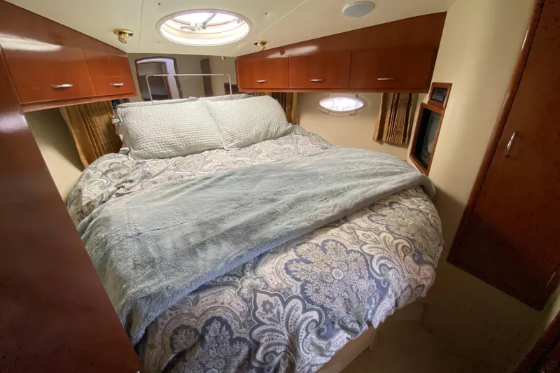 Slide: The Image of Luxurious bedroom interior of 2004 Carver 36 Super Sport yacht with elegant bedding. - 23