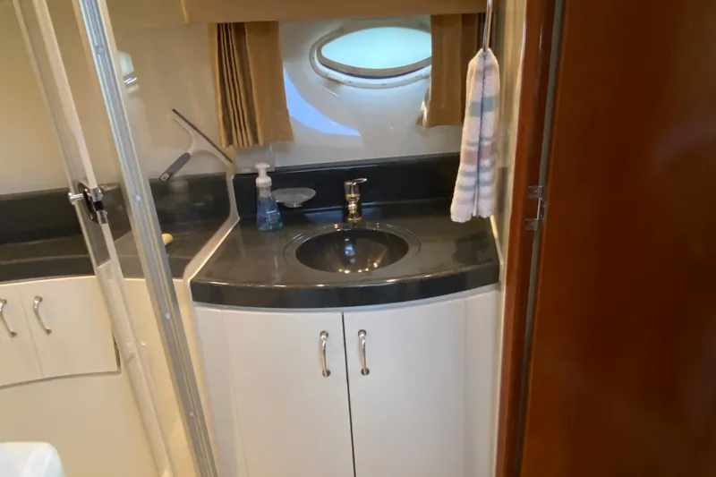 Slide: The Image of Bathroom interior of 2004 Carver 36 Super Sport yacht with sink and porthole window. - 29