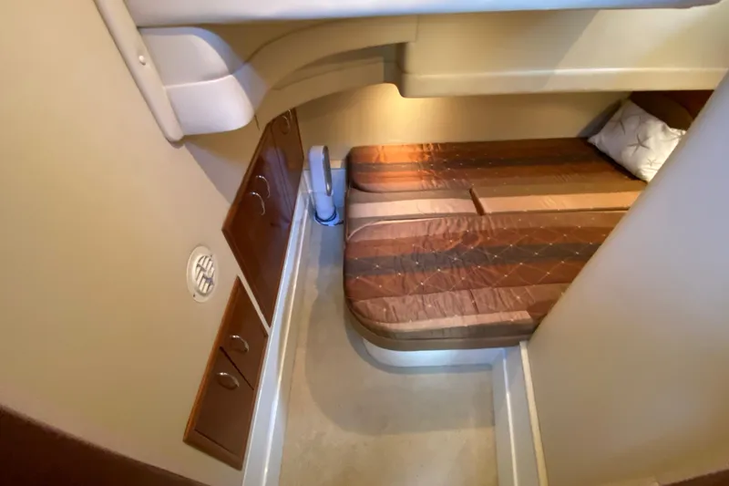 Slide: The Image of 2004 Carver 36 Super Sport cabin interior with bed and storage cabinets. - 30