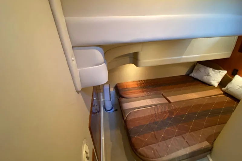 Slide: The Image of 2004 Carver 36 Super Sport cabin interior with cozy bed and pillows. - 31