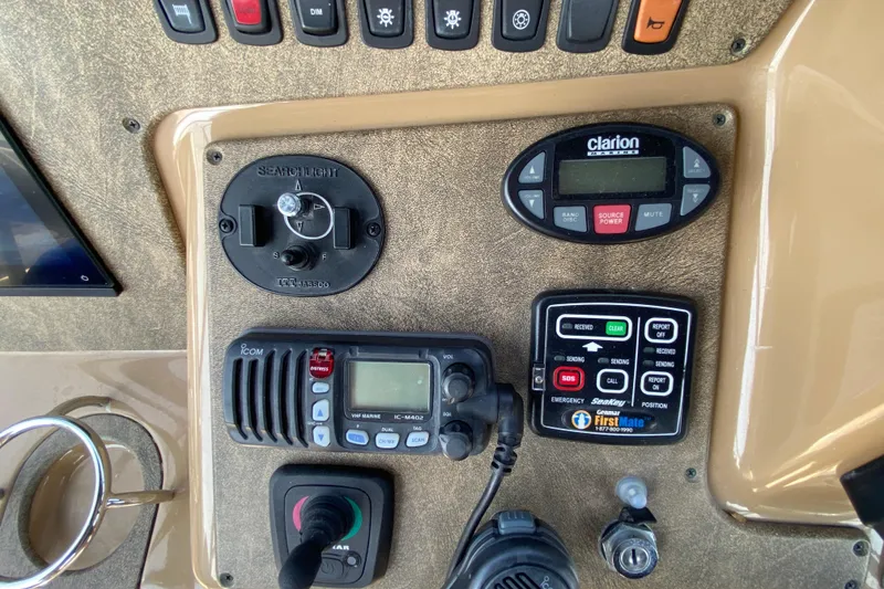 Slide: The Image of Control panel of a 2004 Carver 36 Super Sport boat with various electronic devices. - 37