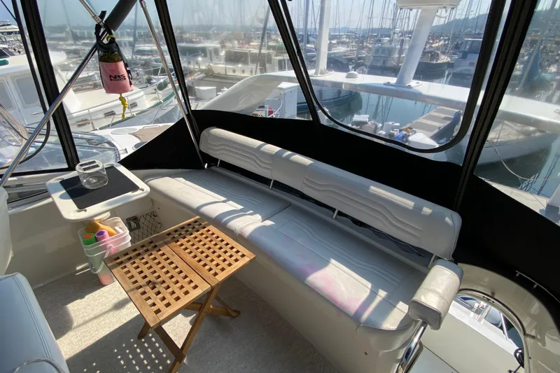 Slide: The Image of Interior of 2004 Carver 36 Super Sport yacht with seating and marina view. - 43