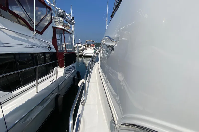 Slide: The Image of 2004 Carver 36 Super Sport yacht docked beside other boats in a marina. - 46