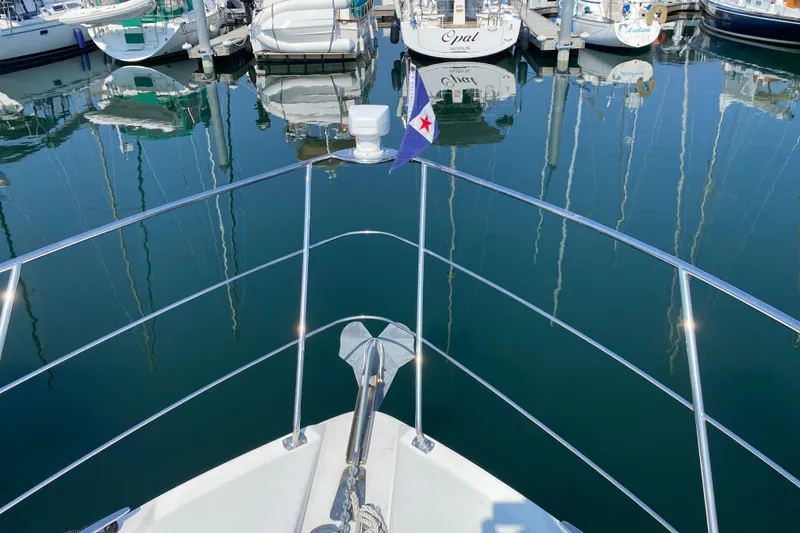 Slide: The Image of Bow view of 2004 Carver 36 Super Sport yacht in marina, calm water reflections. - 47